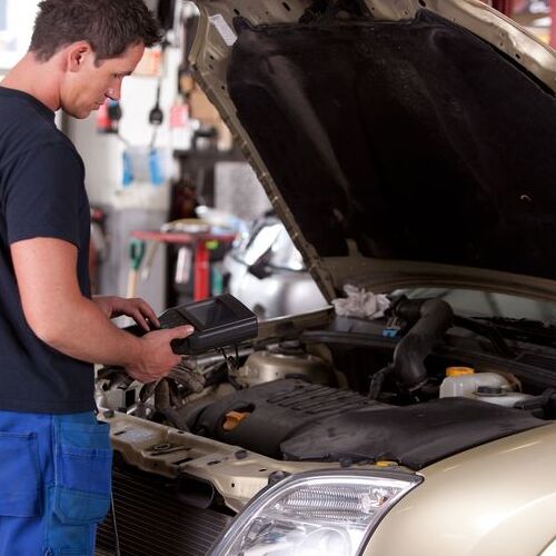 A Mechanic Runs a Diagnostic on a Car.