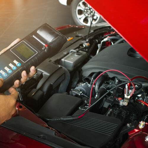 A Mechanic Tests a Car Battery.