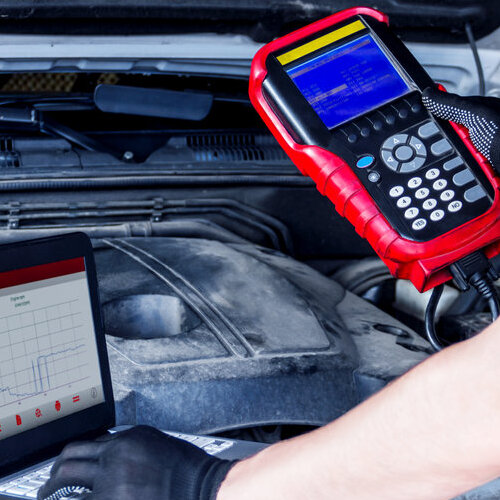 checking a car's engine with an electrical monitor