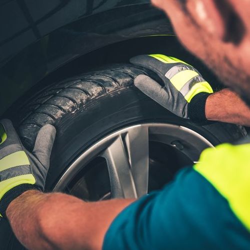A Technician Checks a Tire.