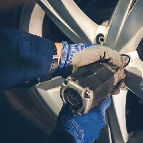 A Technician Removes A Tire.