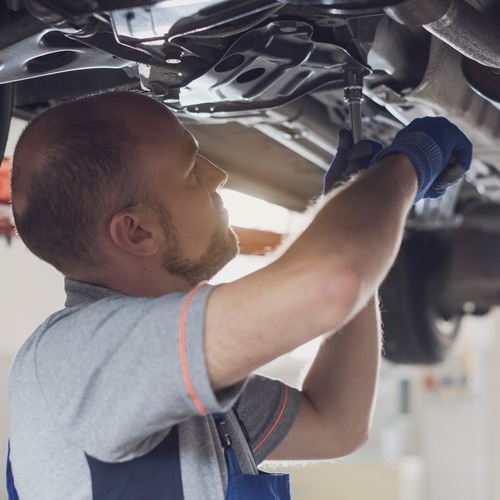 An Auto Technician Changes Brake Fluid.